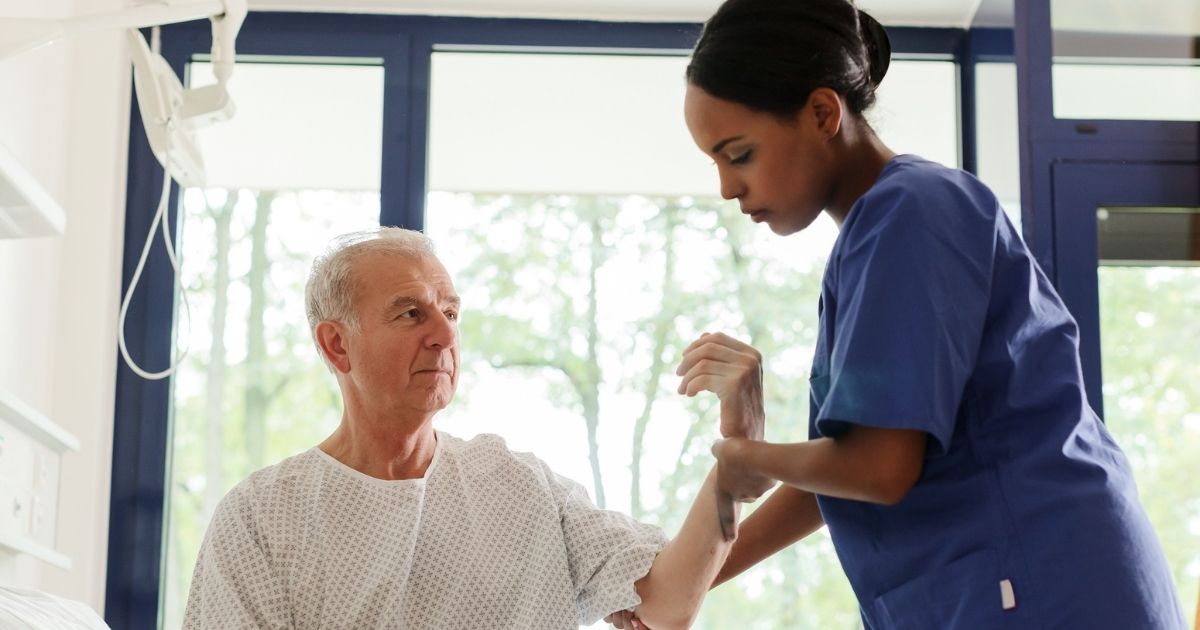 Nurse Speaking and helping patient